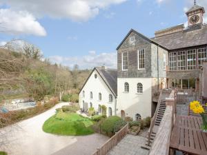 a large white building with a clock tower on top at Tuckenhay, 1 Salle Cottage, - Fcq in Ashsprington