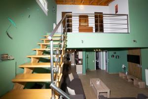 a spiral staircase in a room with green walls at Alex house in Kouramaditika