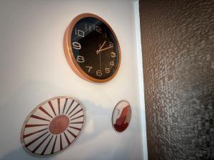 a clock on a wall next to a fan at Duplex Deluxe in Torreblanca