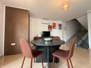 a dining room with a black table and chairs at Duplex Deluxe in Torreblanca