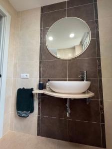 a bathroom with a sink and a mirror at Duplex Deluxe in Torreblanca