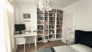 a bedroom with a desk with a computer and a book shelf at Apartament Rutkiewicz in Łańcut