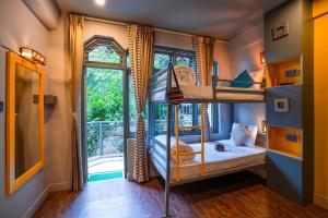 a room with two bunk beds and a window at PACK Mcleodganj in McLeod Ganj