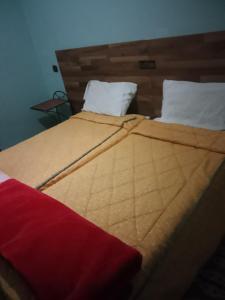a close up of a bed in a room at Hôtel des cedresazrou in Azrou