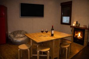 a bar with two glasses of wine and a fireplace at Casa Rural Casa de Chocolate in Cuevas del Valle +6 photos