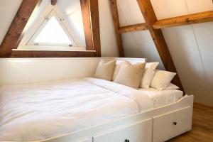 a bed in a room with a window at Villa Verano in Noordwijk aan Zee
