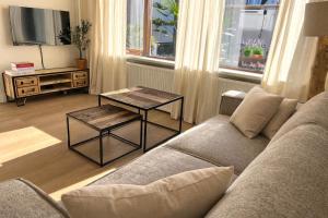 a living room with a couch and a table at Santos in Noordwijk aan Zee