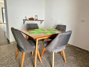 a dining room table with four chairs around it at APARTAMENTO COMPLETO, Piedra viva in Zapatoca