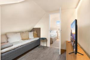 a living room with a couch and a bedroom at Central Apartment - Calm - No traffic in Stavanger