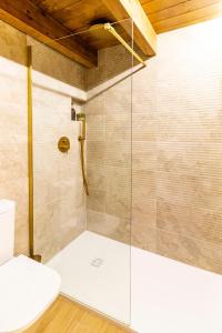 a shower with a glass door in a bathroom at Refugi dels Somnis - Turismo con encanto en Onda in Onda