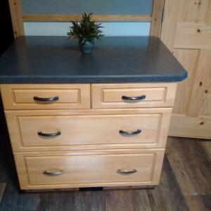 a wooden dresser with a blue counter top at Jasper Way Inn Resort & Campground in Clearwater