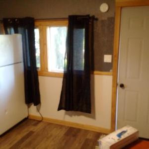 a room with a refrigerator and a window at Jasper Way Inn Resort & Campground in Clearwater