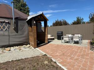 a gazebo with a table and a grill at Riverview Yurt in Tarras