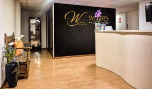 a store lobby with a counter with a welcome sign at Hospedaje Boutique Weber's in Gijón