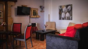 a living room with a couch and a table with chairs at Hotel El Angliru in Cangas de Onís