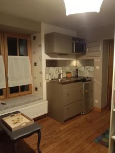 a small kitchen with a sink and a stove at Chez mimi in Anse