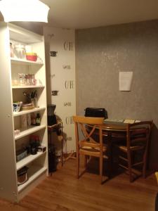 a dining room with a table and a shelf at Chez mimi in Anse