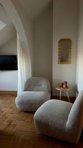 a living room with two chairs and a table at Villa MERLINI w sercu Starego Miasta, Grodzka 19 Lublin in Lublin +71 photos