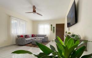 a living room with a couch and a ceiling fan at Balbuena Countryside Villa with Private Pool in San Felipe de Puerto Plata