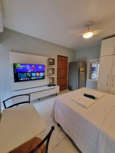 a room with two beds and a tv on the wall at Rio Hotel Reisdence in Água Boa