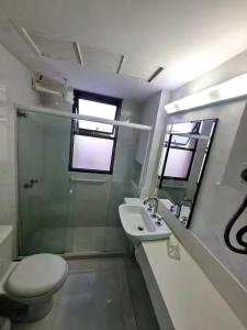 a bathroom with a toilet and a sink and a shower at Rio Hotel Reisdence in Água Boa +44 photos