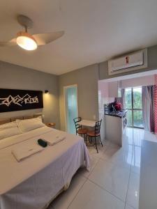 a bedroom with a large bed and a table and chairs at Rio Hotel Reisdence in Água Boa