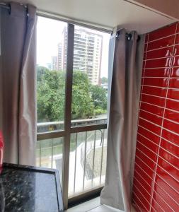 a large window with a view of a building at Rio Hotel Reisdence in Água Boa