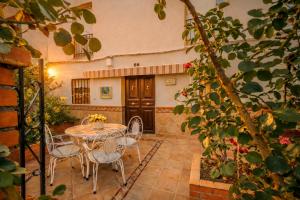 a patio with a table and chairs in a building at Villa Campanilla in Olvera