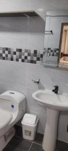 a bathroom with a white toilet and a sink at Nature View in Providencia +46 photos