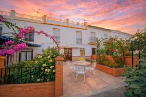 a patio with a table and chairs in front of a building at Villa Campanilla in Olvera