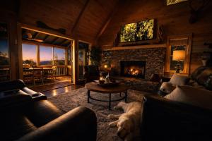 a dog laying in a living room with a fireplace at Bella Vista! Long range MTN views, Hot Tub, Close to town and Lake in Blue Ridge