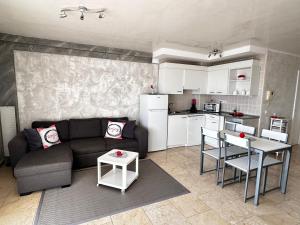 a living room with a couch and a table and a kitchen at Ocean View Elegant Magic Apartment in Palm-Mar