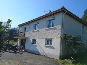 a house with a motorcycle parked in front of it at Les Collines de Compreignac in Compreignac