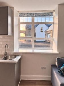 a kitchen with a sink and a window at Aran View Holiday Homes - The Courtyard Suite - Cozy for two in Doolin