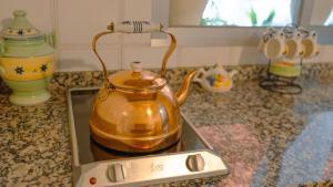 a tea kettle sitting on top of a stove at Villa Campanilla in Olvera