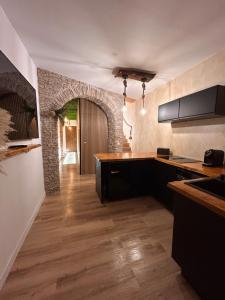 a kitchen with a counter and a stone wall at Fuera de tiempo in Albalat de la Ribera