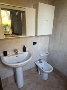 a bathroom with a sink and a toilet at Casa Aurora Gardalake in Cavalcaselle +11 photos
