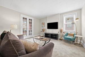 a living room with a couch and a tv at Spacious & Clean 3BR 2 Balconies Parking in Pittsburgh