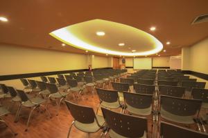 an empty room with chairs and a large ceiling at Hotel Britania Miraflores in Lima