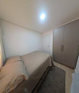 a small bedroom with a bed and a closet at Apartamento aconchegante e tranquilo in Foz do Iguaçu