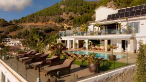 a villa with a swimming pool on a hill at Villa Maya Bali Inspired Villa in Mijas