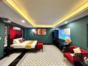 a hotel room with a bed and a couch at New Pearl Hotel HCM in Ho Chi Minh City