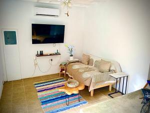 a living room with a bed and a couch at Playa Negra Art House in Hone Creek