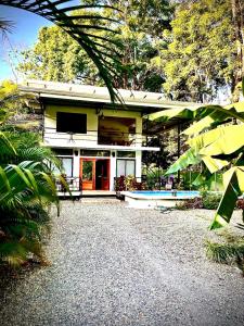 a house with a pool in front of it at Playa Negra Art House in Hone Creek