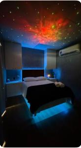 a bedroom with a bed with a painting on the ceiling at Canto Flix in Brasília