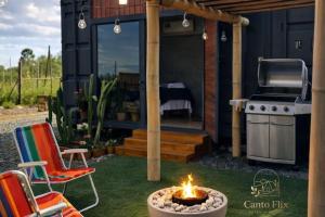 a backyard with a grill and a fire pit at Canto Flix in Brasília