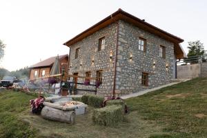 a large stone house with hay in front of it at Kula 1960 Luxury Stone House in Rožaje
