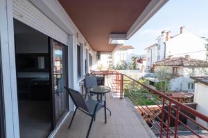 a balcony with two chairs and a table on it at Villa White Lake - Ohrid Center Lakeside Accommodation in Ohrid