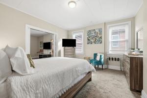a bedroom with a bed and a sink and a television at Spacious & Clean 3BR 2 Balconies Parking in Pittsburgh