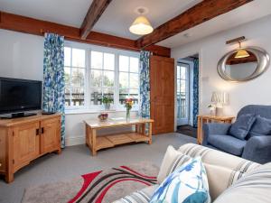 a living room with a couch and a tv at Tuckenhay, Mill Spring - Fmf in Ashsprington